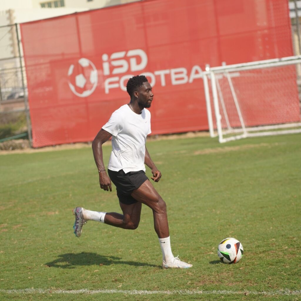 Football player in action during a match in Dubai, captured by Zypix Sports Photography