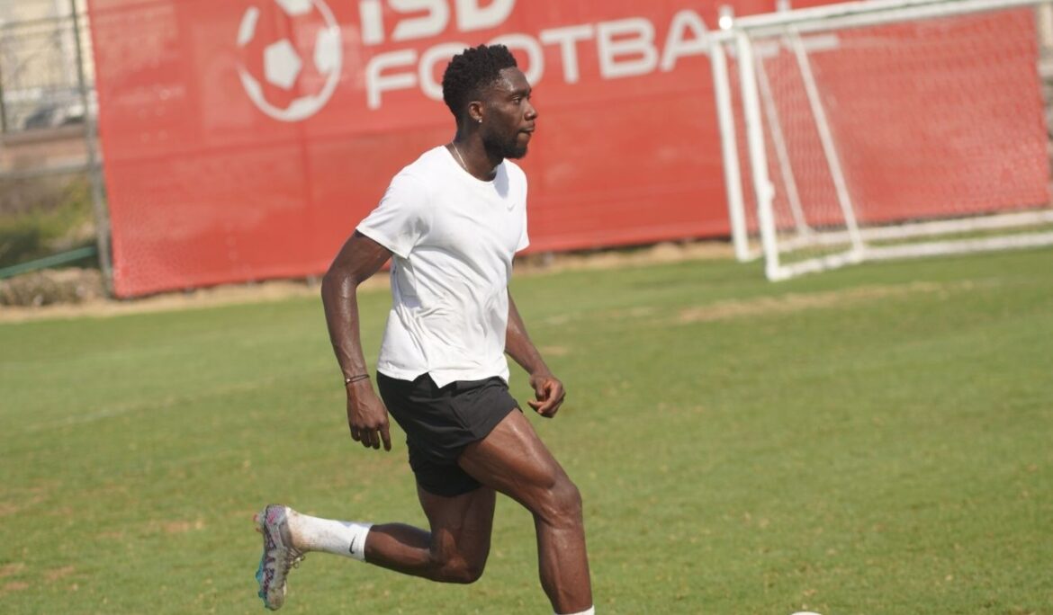 Football player in action during a match in Dubai, captured by Zypix Sports Photography