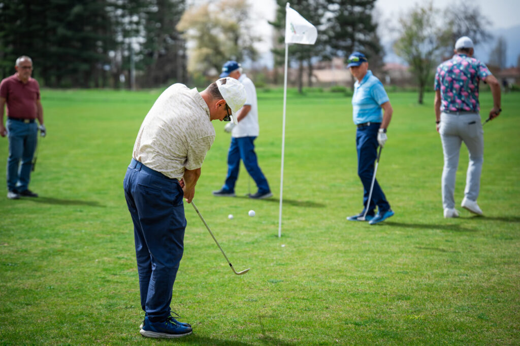 Golfer swinging club during professional golf tournament photography in Dubai – Zypix Sports Photographer