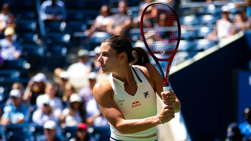 Action shot of a tennis player serving during a tennis tournament in Dubai, captured by Zypix Photography